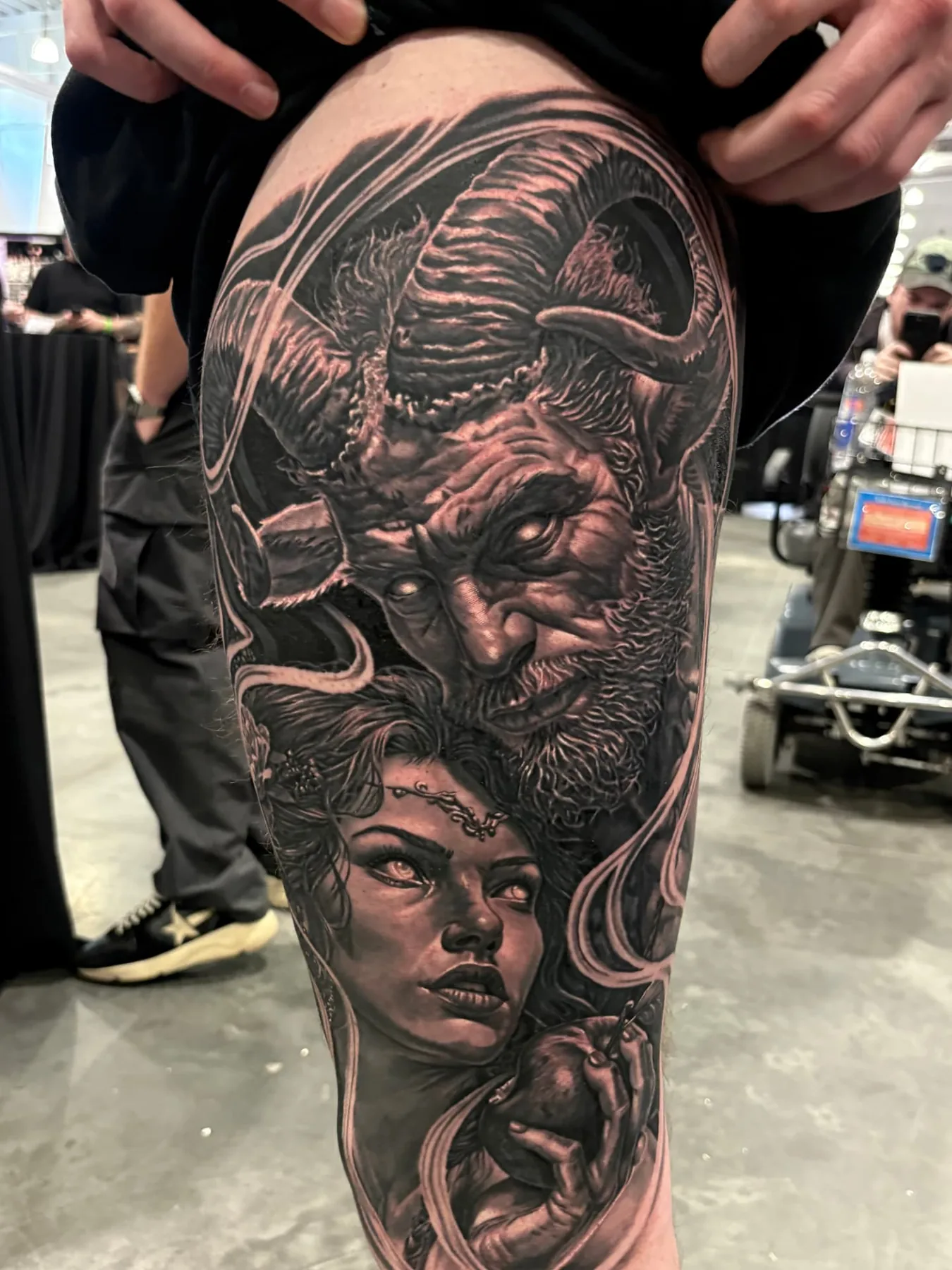 Black and grey realism leg sleeve with horned demon and woman's portrait