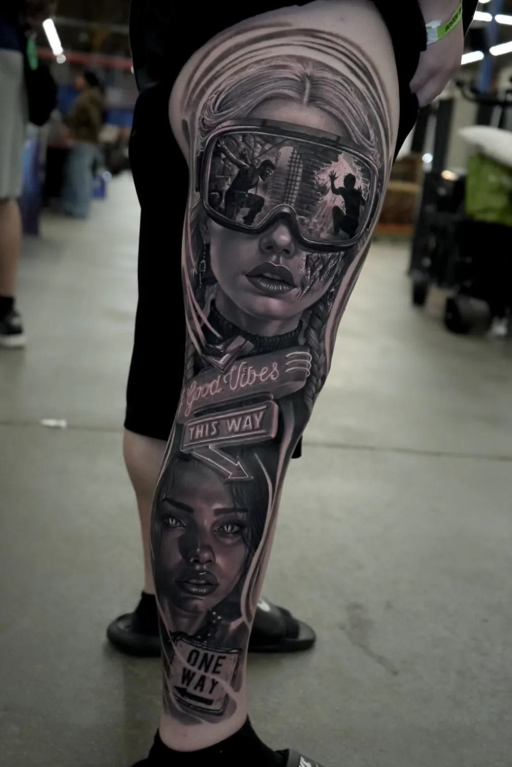 Black and grey portrait leg sleeve with neon signage